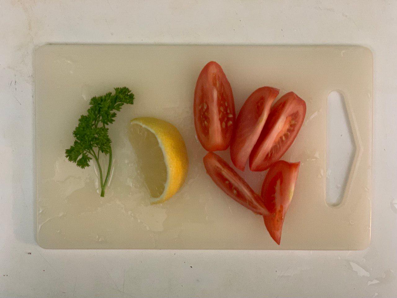 Cut 1/2 <b>tomato</b> and a <b>lemon</b> wedge. Wash <b>cabbage</b> and <b>parsley</b>.