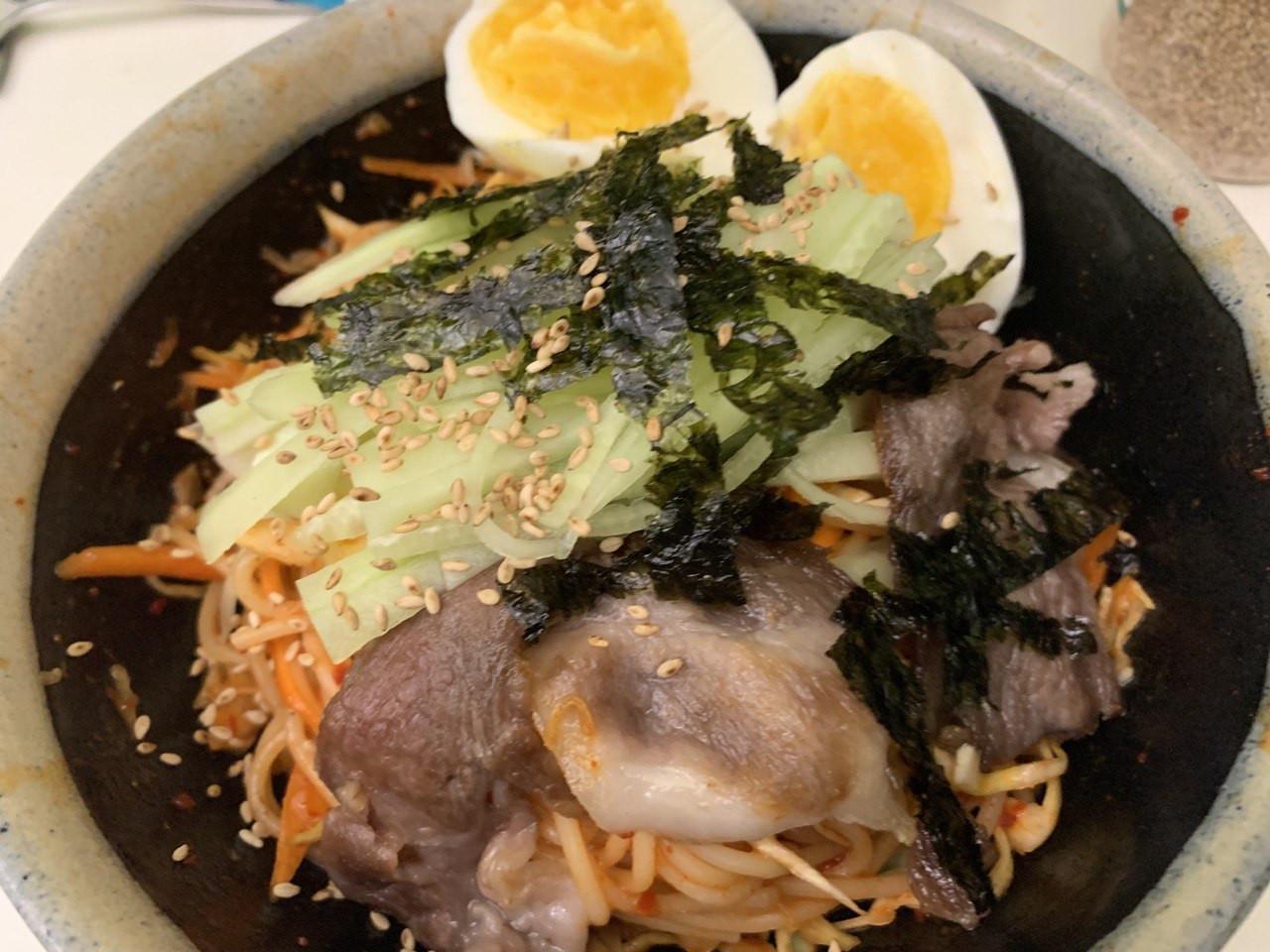 Place <b>drained noodles</b>, handful of <b>cabbage</b> and <b>carrot</b> in bowl. Stir in 3tbsp of <b>jjolmyeon sauce</b>. Mix. Top with cut <b>cucumber</b>, <b>pork</b>, <b>egg</b>, <b>seaweed</b> & <b>sesame seeds</b>.