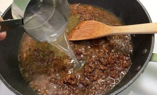 In a big pan, fry our homemade-<b>mapo tofu sauce</b> until melted. Add 1.25cup (300ml) water.